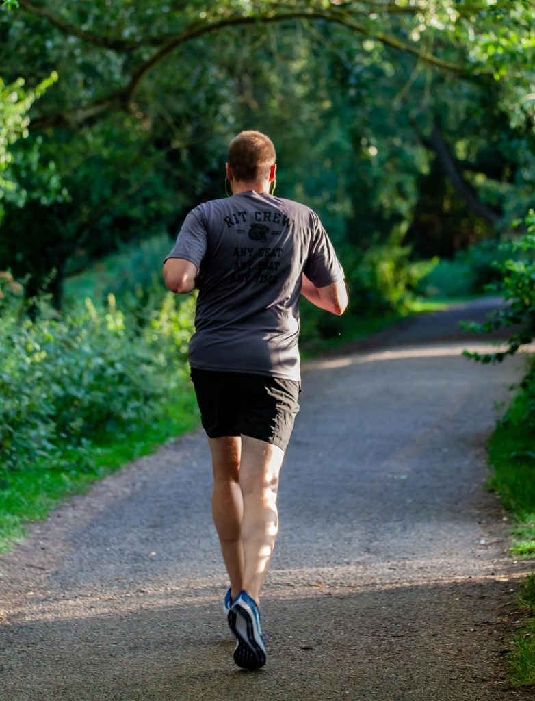 runner fitness and exercise guide for Fit man jogging at sunset feeling energetic and happy 