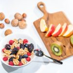 Apple slices topped with almond butter and chia seeds – a perfect example of balanced plant-based snacks for mid-day energy.