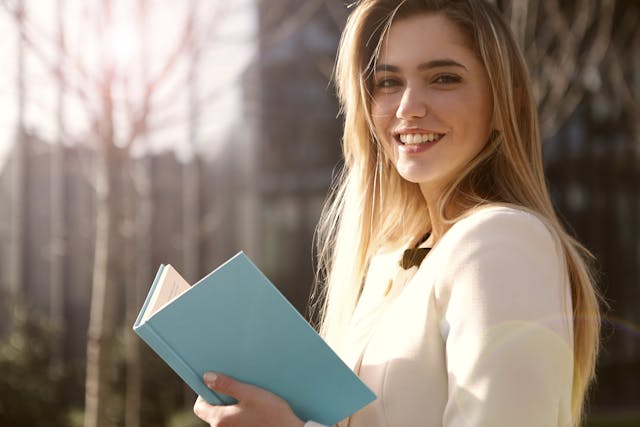 Smiling woman enjoying sunrise while practicing 5-minute daily habits for happiness