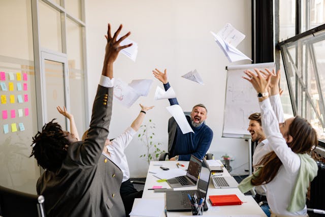 Office workers resetting energy with desk yoga stretch routine 
