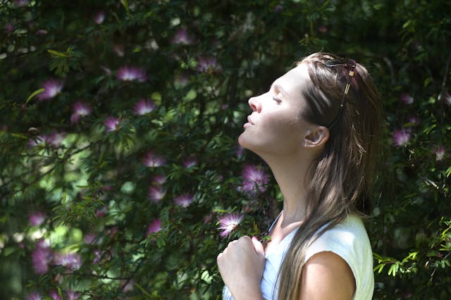 Person reflecting on 5-minute daily habits for happiness in a peaceful natural setting