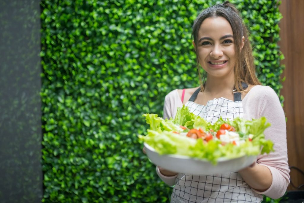Smiling person enjoying balanced eating habits with fresh healthy food