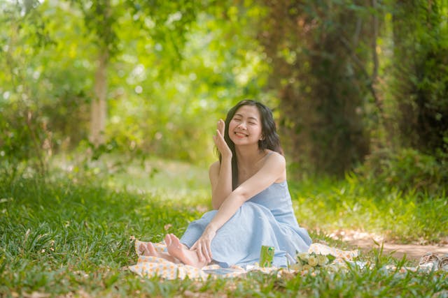 Happy woman showing glowing skin following natural skin brightening tips