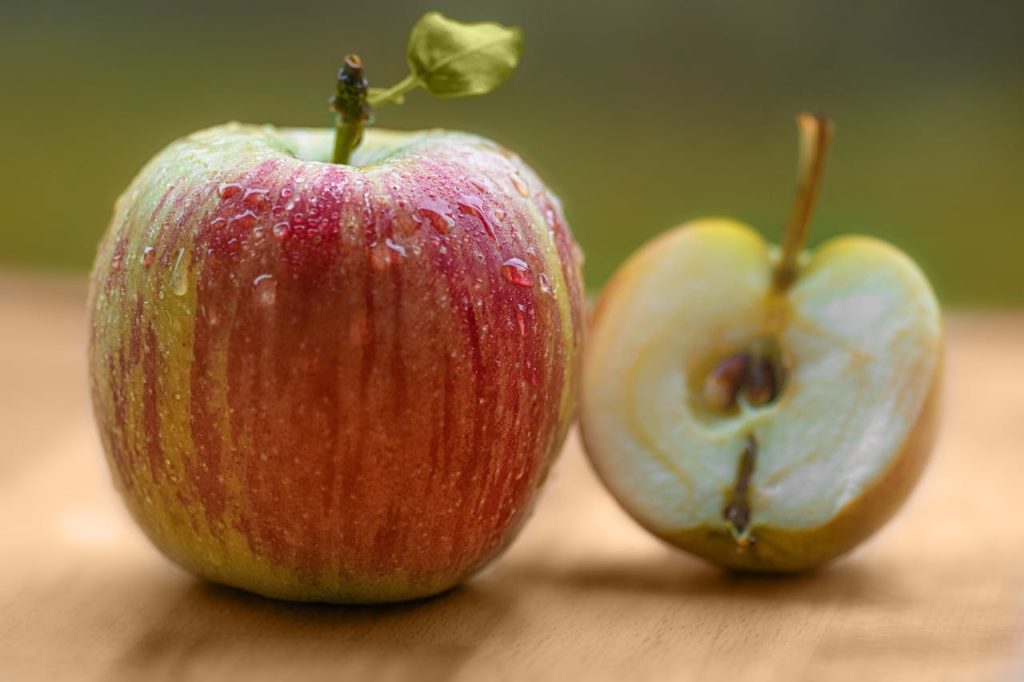 Fresh apples on a wooden table showing the Health Benefits of Apples