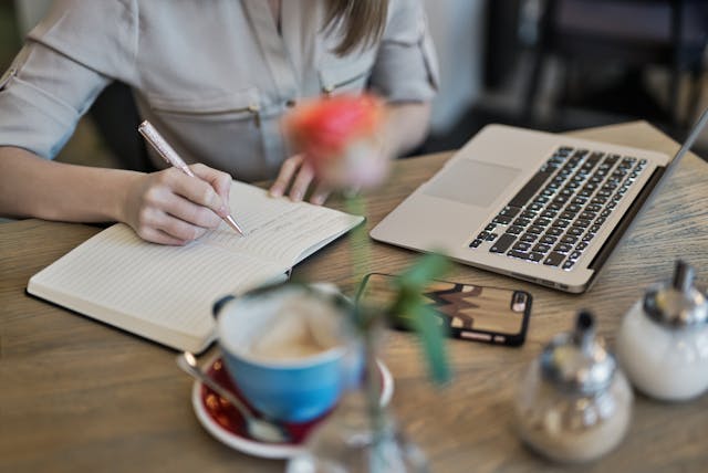 Open journal with coffee and pen encouraging reflection and growth mindset motivation 