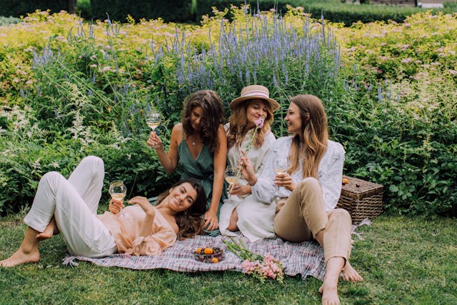 Confident women's smiling with glowing natural skin outdoors, representing natural beauty