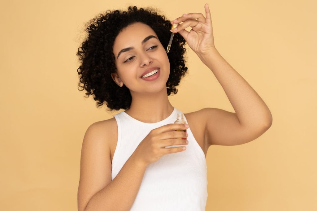 Woman applying natural oils for glowing skin as part of skincare routine