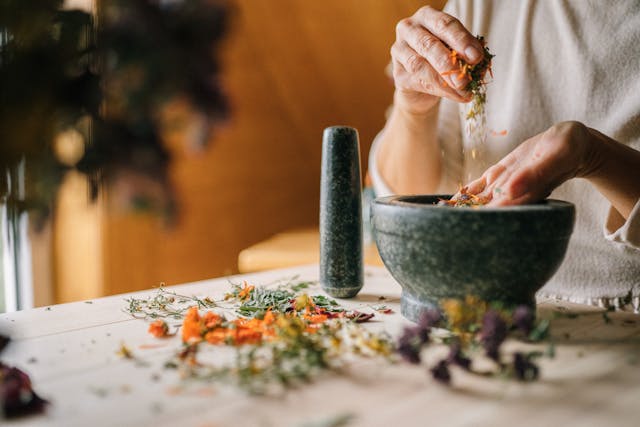 Flat lay of natural skin care products including aloe vera, essential oils, and herbs for glowing skin