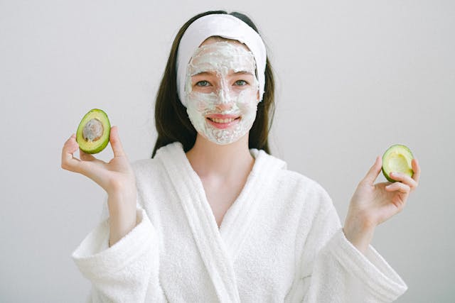 A woman following a natural skin care routine at home using homemade organic ingredients for glowing healthy skin