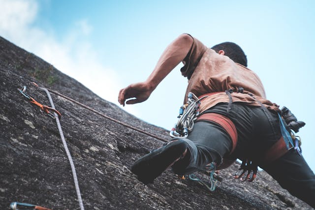 Self Growth Motivation Tips illustrated with a person climbing towards success