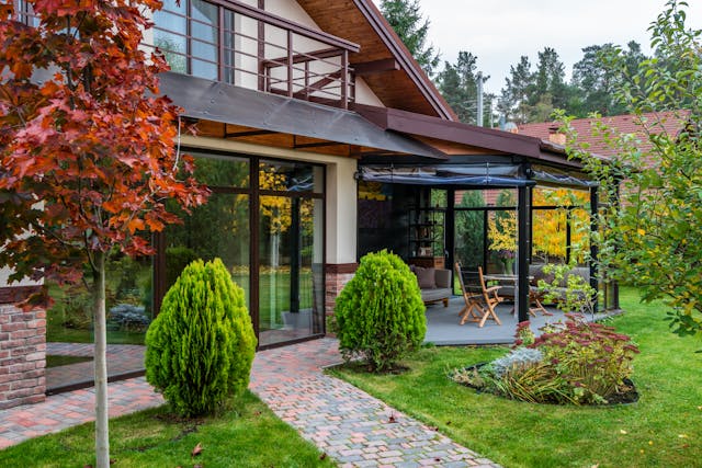 Beautiful summer garden with lush lawn and flowers showcasing smart summer garden hacks.