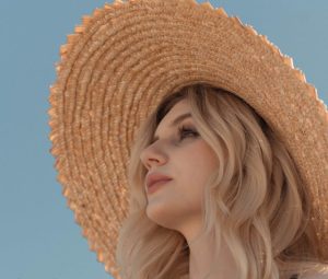Women with hat protecting skin from sun for natural glowing skin 