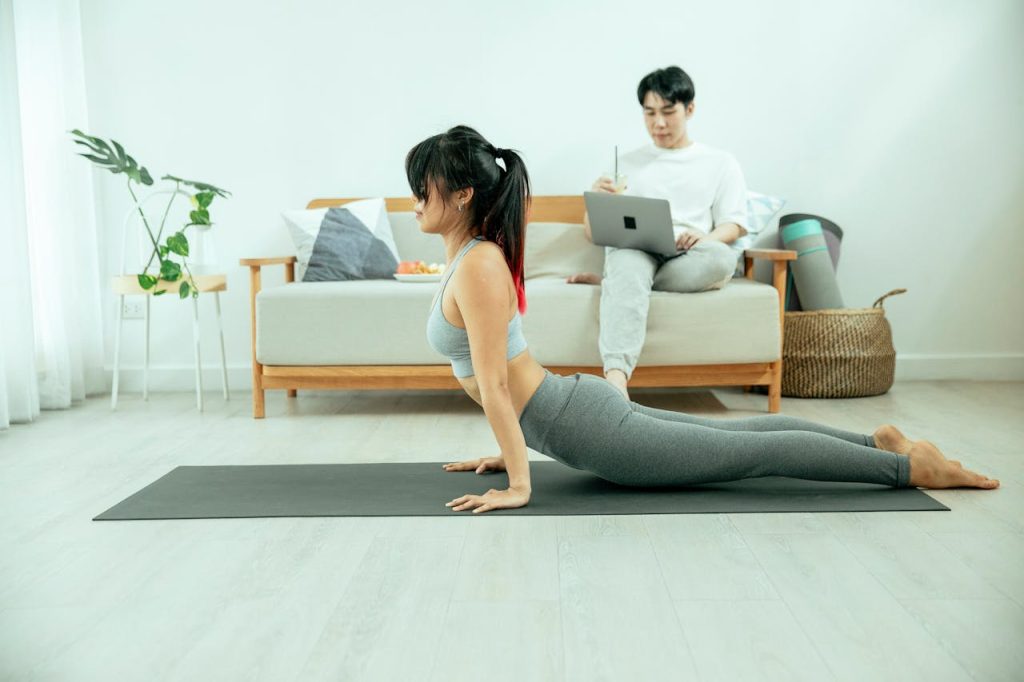 Woman doing 5-minute daily stretching routine on yoga mat in the morning