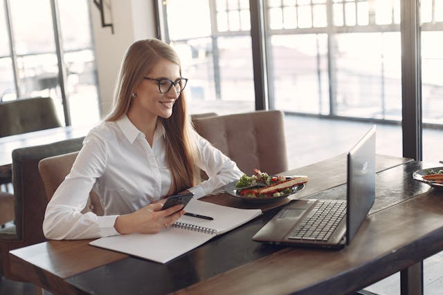 Person working productively with financial charts in background to boost productivity and financial health