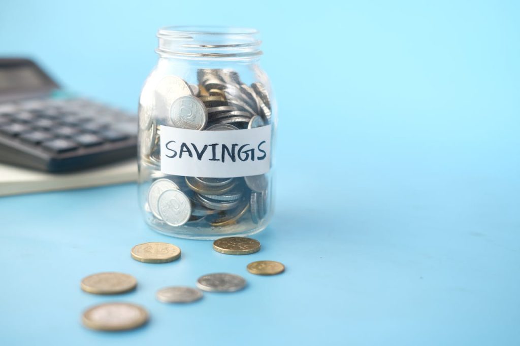 Building an Emergency Fund with savings jar and coins for financial security