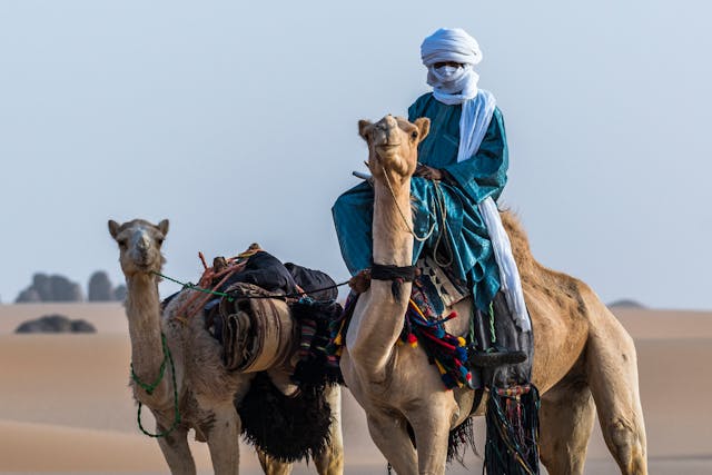 Travelers enjoying cultural adventure travel by engaging in traditional experiences