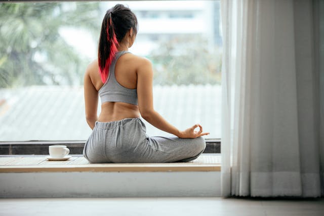 Relaxed woman after completing her daily stretching routine enjoying calmness