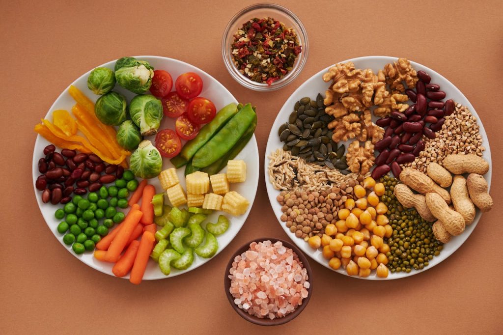 A colorful plate showing all essential nutrients for health including vegetables, fruits, nuts, and whole grains 🌱🍊🥗