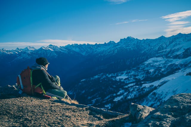 Final thoughts on best hiking trails for wellness with a peaceful view of a hiker meditating at sunset on a mountain