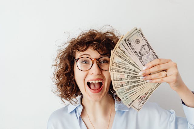 Happy person celebrating financial success and savings achieved through best budgeting apps for personal finance.