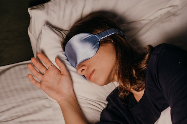 Women sleeping peacefully at night showing the benefits of quality sleep for mental health
