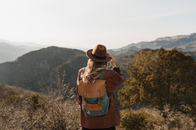 Introduction to the best hiking trails for wellness showing a solo hiker walking through a serene green path