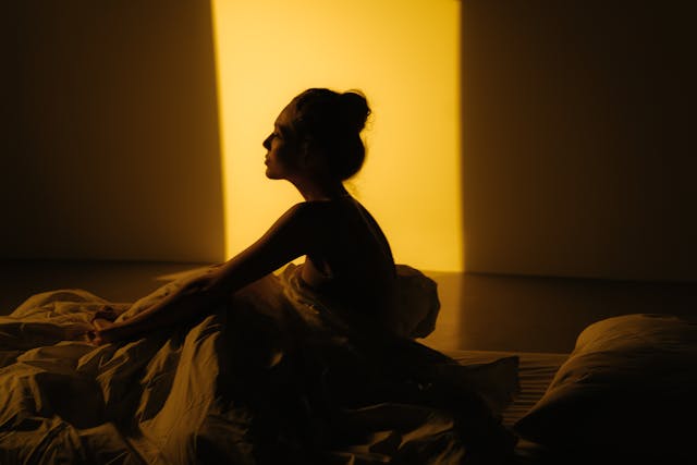 Young woman practicing sleep meditation techniques before bedtime
