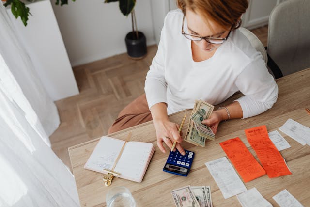 Money saving hacks concept with coins and budget planner on table