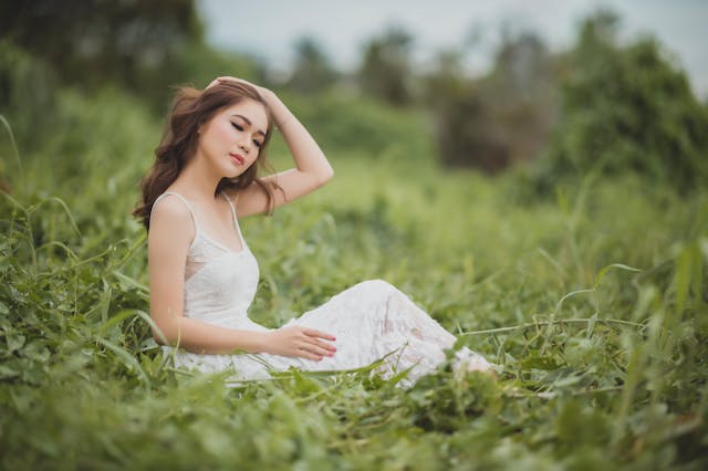 Smiling woman enjoying natural skin relief with a healthy glowing face in natural light