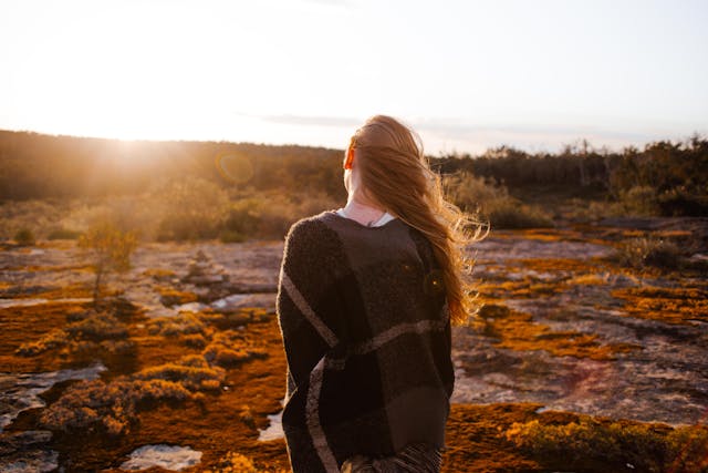 Traveler reflecting during sunset after discovering hidden travel gems