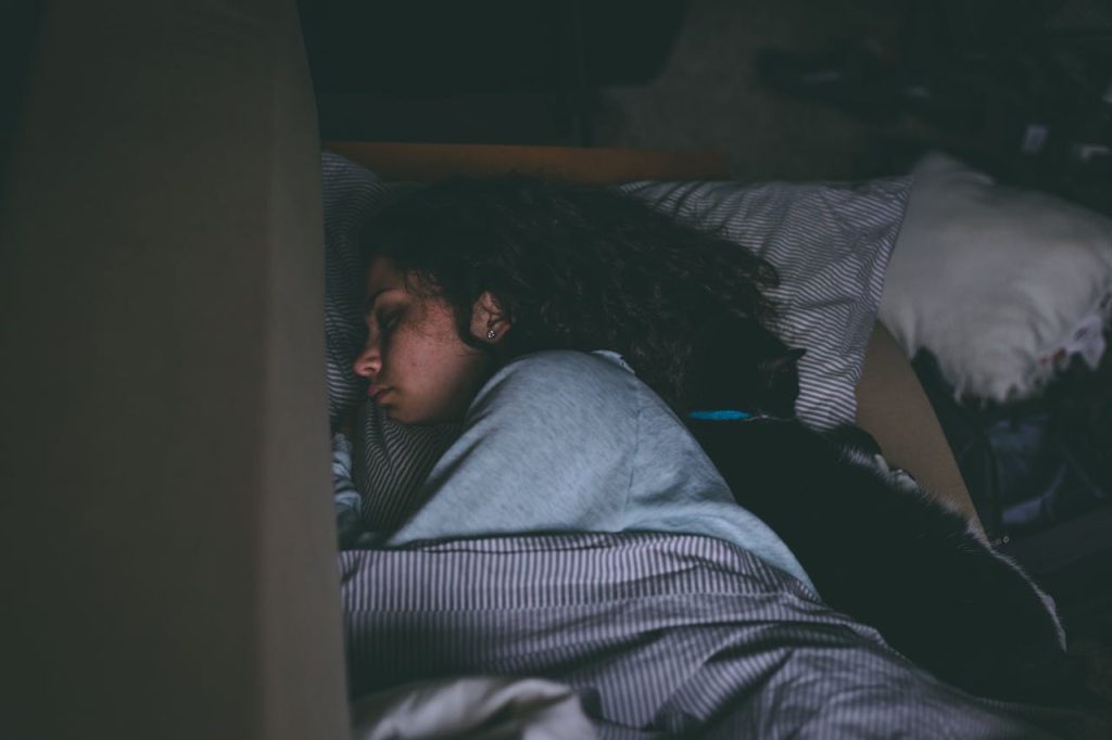 Women sleeping peacefully at night, highlighting quality sleep for mental health