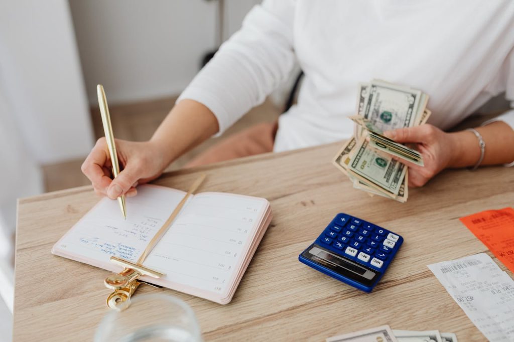Top 7 money saving hacks with notebook, coins, and budget planning workspace