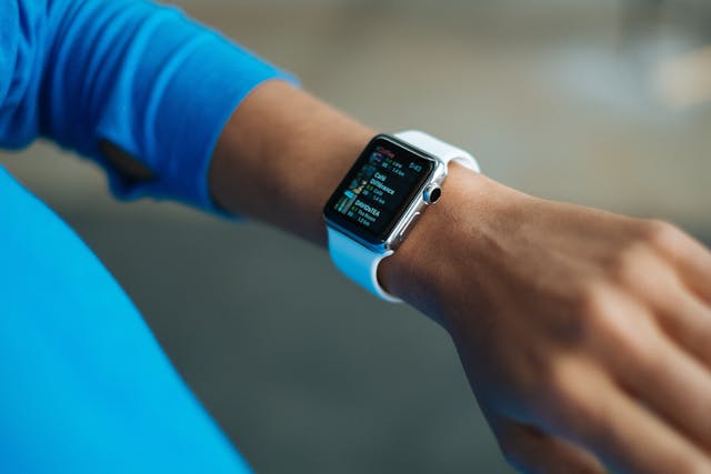 Smart wearable fitness trackers displaying health data on wrist